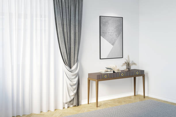 istock A bright room with an illuminated vertical poster on a white wall, flowers in a vase, decor on a console near a large window with classic gray curtains, and gray carpet on a parquet floor. 1429144004