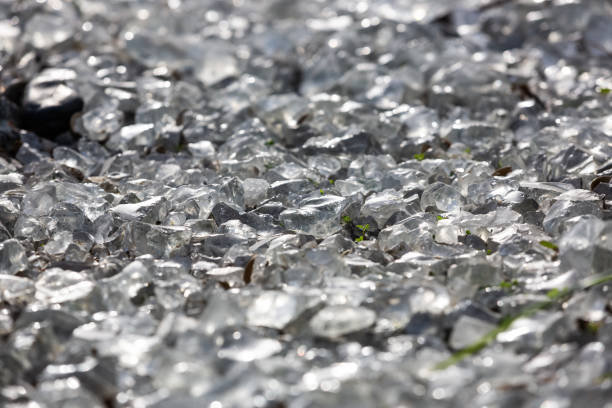Background from a transparent glass stone. Artificial turf. Pieces of glass. Pure crystal quartz