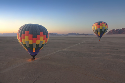 Two beautiful hot air balloons drifting though the sky.