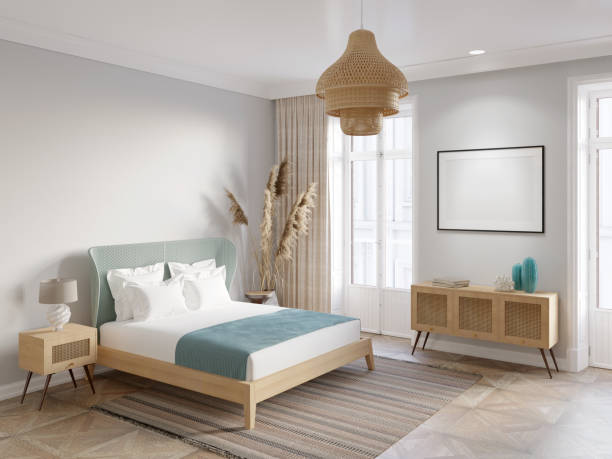 A bedroom with an illuminated blank horizontal poster above a curbstone with rattan doors, a lamp on a nightstand next to a bed with a blue wicker headboard, and large spikelets near a door.