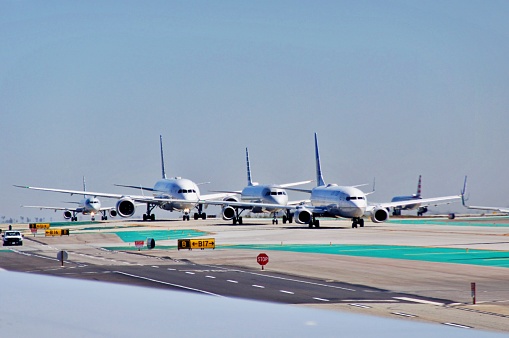 Filling cargo by side profile of an airplane on airport.