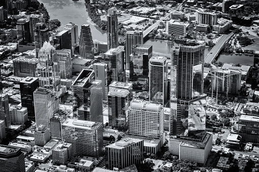 Aerial view downtown Austin, Texas from about 2000 feet in altitude during a helicopter photo flight processed in black and white with a subtle blue tone.