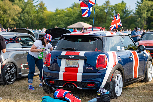 Oakville, Ontario, Canada- September 18, 2022.  MINI COOPER cars and fans on British Car Day show  in public park in suburb of Toronto, Canada. British Car Day is the largest British car show in North America. Over 1000 cars on display and 50 vendors. Held the 3rd Sunday of September at Bronte Park, Oakville, Ontario. Mini car has been around since 1959 and has been owned and issued by various car manufacturers.