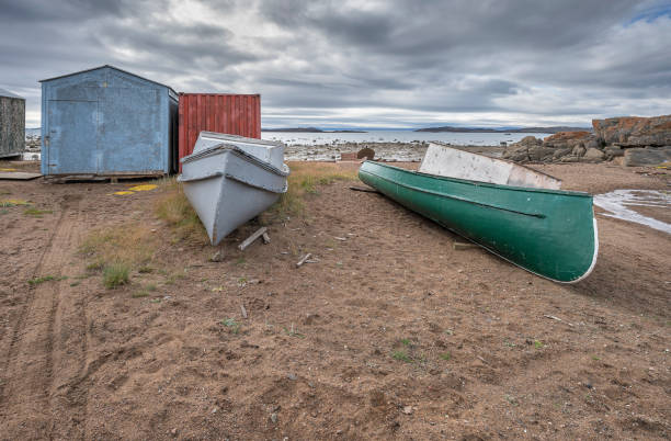 two canoes and a shed on the edge of the arctic ocean - baffin island imagens e fotografias de stock