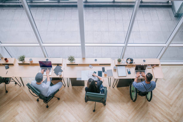 diversify asian multi-ethic white collar worker busy working in office workstation in open plan - high angle view people people in a row directly above imagens e fotografias de stock