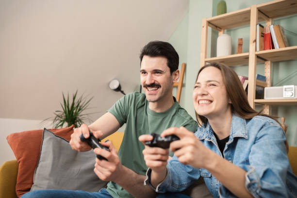istock Happy couple gaming at home 1429191838