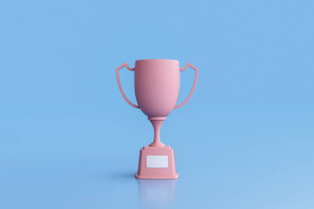istock Pink trophy cup isolated on blue background 1429193767