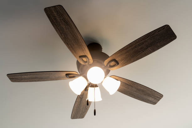 Ceiling Fan in Motion Residential ceiling fan in motion on a white ceiling. ceiling fan stock pictures, royalty-free photos & images