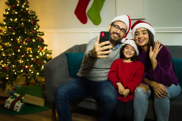 istock Happy parents and daughter taking a selfie during christmas 1429206493