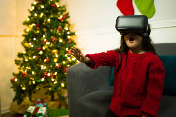 istock Cheerful kid playing on christmas with virtual reality glasses 1429206675
