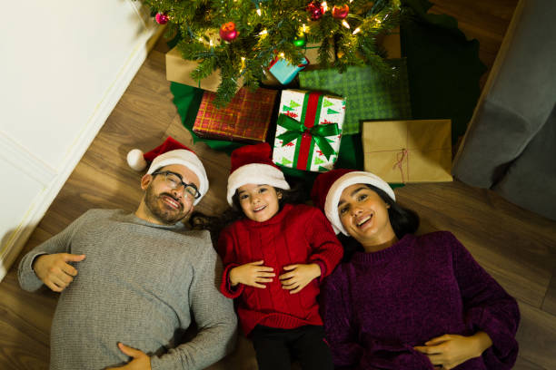 istock Beautiful happy family smiling under the christmas tree 1429206793