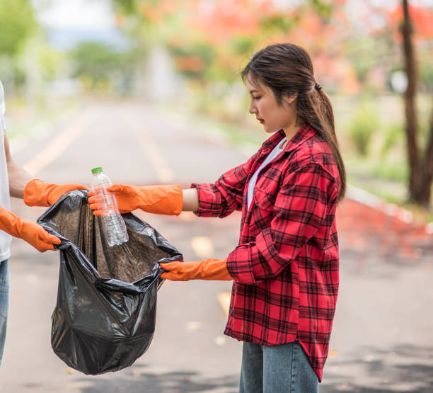 istock Men and women help each other to collect garbage. 1429218869