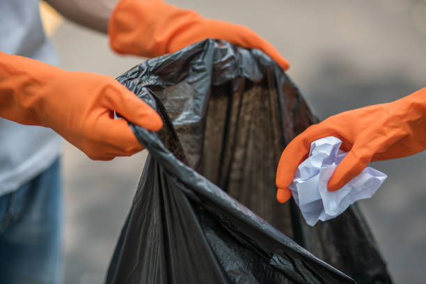 istock Men and women help each other to collect garbage. 1429218888