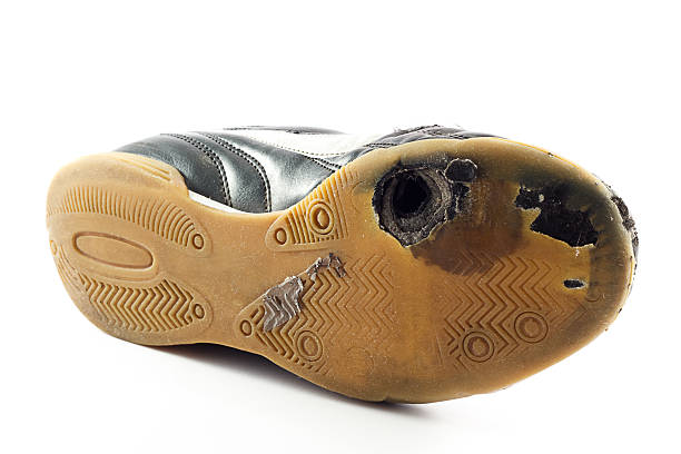 Worn out Sports Shoe with hole stock photo