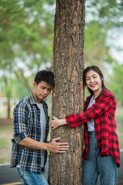 istock Men and women standing and hugging trees. 1429222033