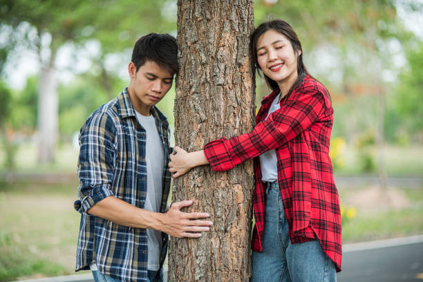 istock Men and women standing and hugging trees. 1429222036
