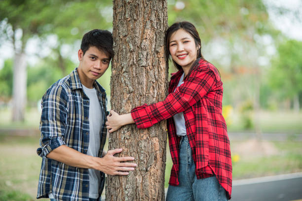 istock Men and women standing and hugging trees. 1429222256