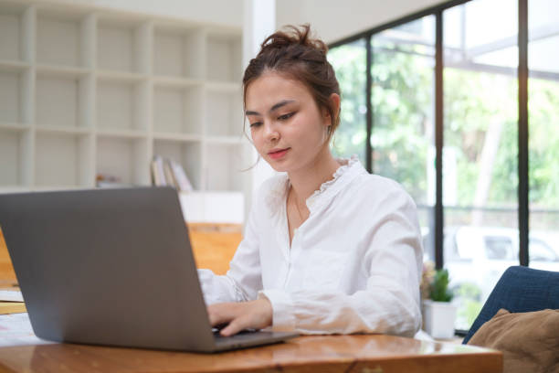 istock Millennial asian businesswoman using laptop and working financial document at office. 1429224821