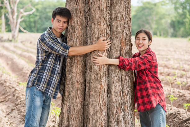 istock Men and women standing and hugging trees. 1429225172