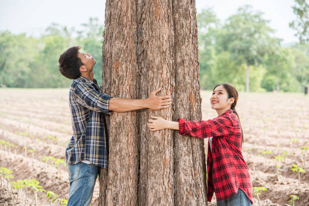 istock Men and women standing and hugging trees. 1429225181