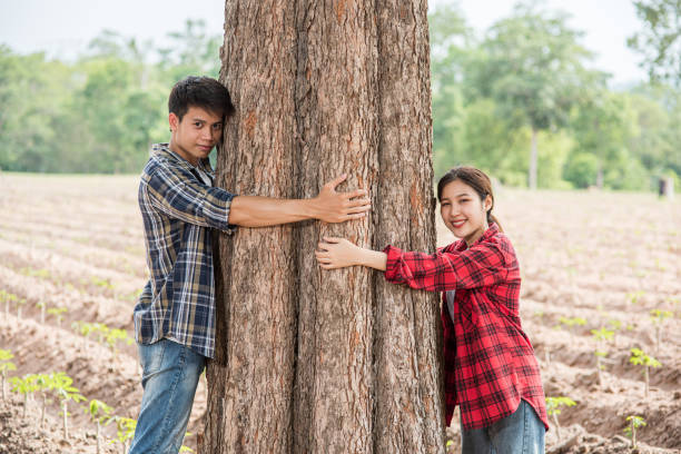 istock Men and women standing and hugging trees. 1429225182