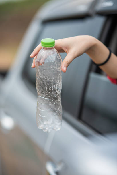 istock Holding a water bottle and sticking out the car. 1429225937