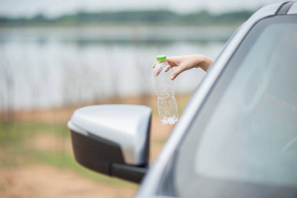istock Holding a water bottle and sticking out the car. 1429225984