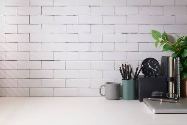 istock Creative workplace with books, coffee cup, pencil holder and laptop. Home office desk, Copy space for your text. 1429226035