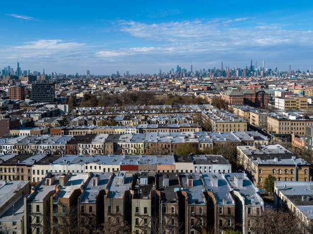 quartier résidentiel à bushwick, brooklyn, new york, dans l’après-midi ensoleillé, avec le manhattan isolé en toile de fond. - manhattan aerial view brooklyn new york city photos et images de collection