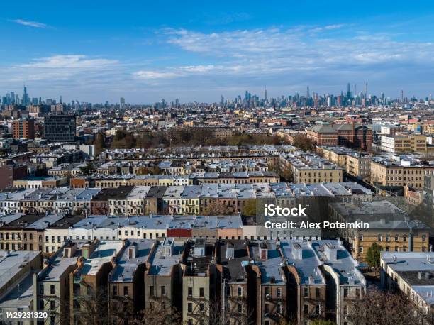 Residential District In Bushwick Brooklyn New York In The Sunny Afternoon With The Remote Manhattan In The Backdrop Stock Photo - Download Image Now