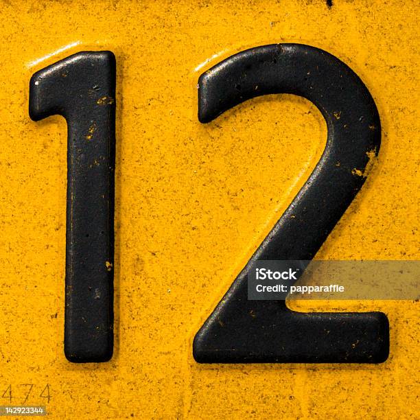 Closeup Of A License Plate With The Number Twelve Stock Photo - Download Image Now - Number 12, Black Color, Design