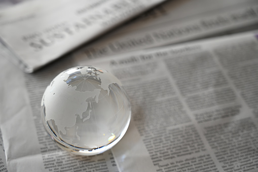 glass globe on newspapers