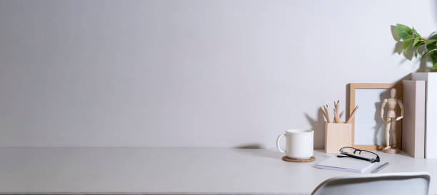 istock Comfortable workplace with coffee, stationery and houseplant on white table. 1429234747
