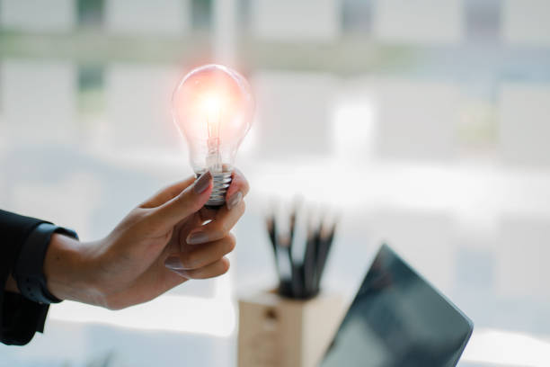 istock Hand holding a light bulb. Ideas with innovation and inspiration and creative ideas to save energy. 1429238169