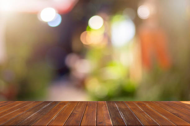 istock Empty brown wooden table and bokeh blur background for displaying your products. 1429238181