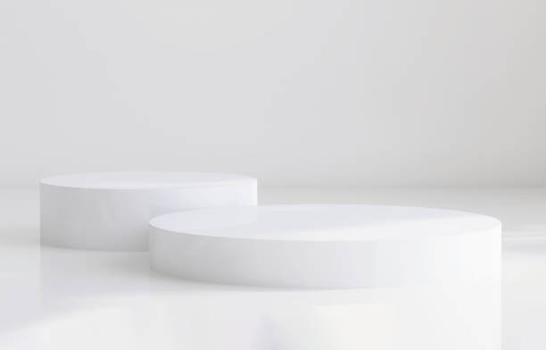 istock Glossy white round cylinder ceramic podium with sunlight and shadow on white wall and floor 1429238648