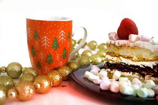 Closeup chocolate cake on the plate, Christmas atmosperic mood. Christmas tree decorations garland