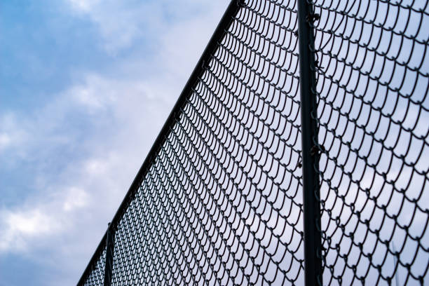 Chain link fence against under the sky