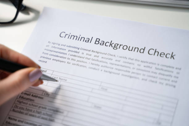 istock Human Hand Filling Criminal Background Check Application Form 1429256123
