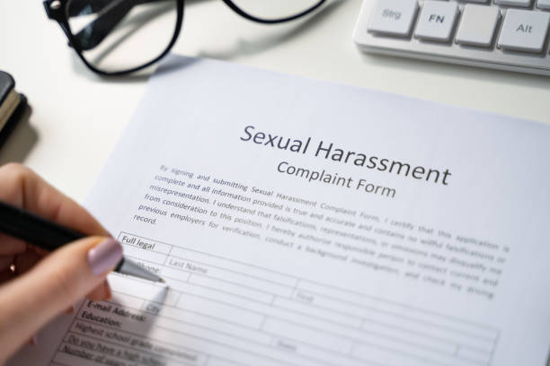 istock Human Hand Filling Sexual Harassment Complaint Form 1429256151