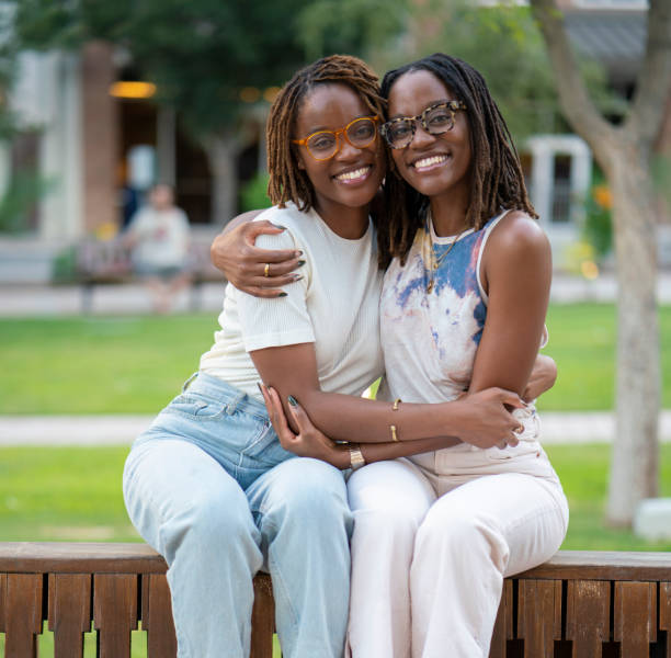 istock Black twin sisters portrait hugging 1429257837