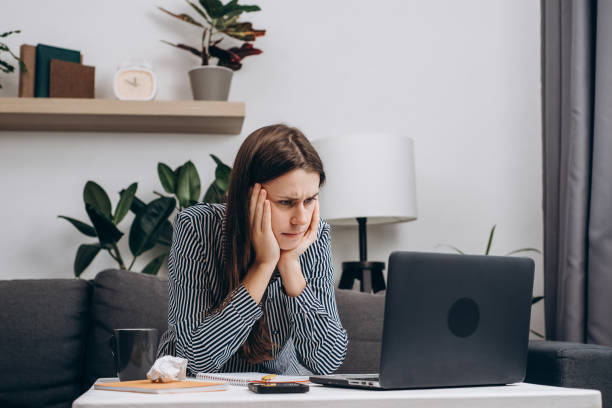 istock Thoughtful girl 20s working or studying on computer tech. Serious pensive woman holding hands on chin lost in thoughts at work with laptop, thinking or new ideas reading online news feeling doubtful 1429260378