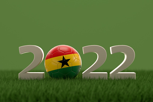 3d rendering of soccer ball with Ghana flag on a grass field.  .