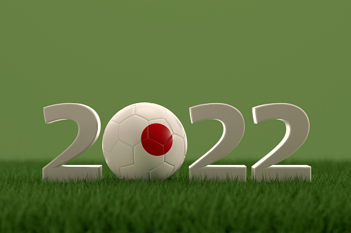 3d rendering of soccer ball with Japan flag on a grass field.  .