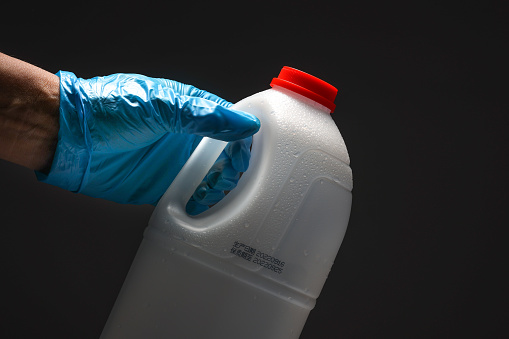 Plastic empty milk bottle on a black background.Empty recyclable milk carton