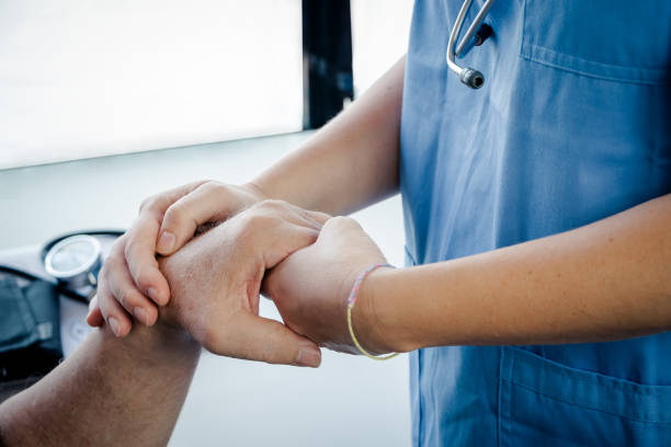 doctor or nurse or sanitary holding hand to patient stock photo