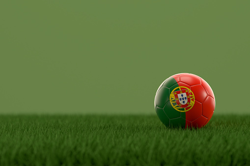 3d rendering of soccer ball with Portugal flag on a grass field.
