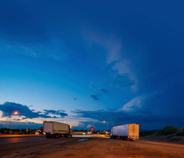 istock Semi-trucks driving fast on the highway 1429272448