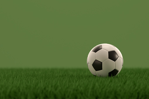 3d rendering of soccer ball on grass field green background