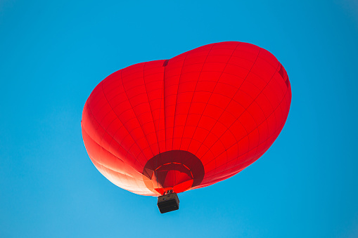 Bright red balloon in the blue sky